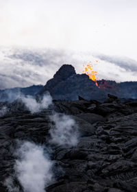 Scenic view of volcanic mountain against sky