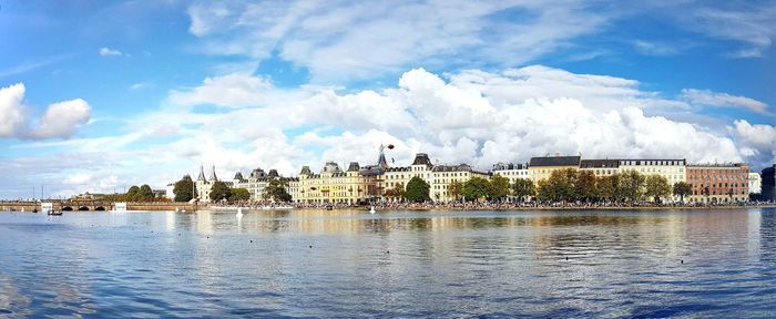 Calm sea with buildings in background