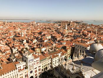 High angle view of town by sea against clear sky