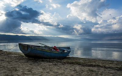 Boat moored on sea against sky