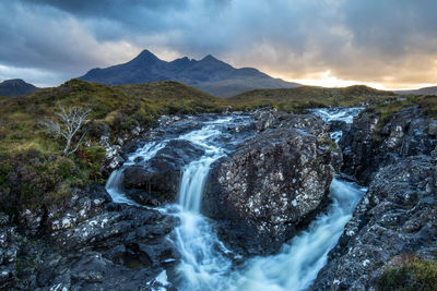 Scenic view of waterfall against sky at night