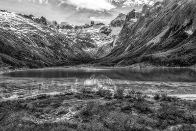 Scenic view of lake against cloudy sky