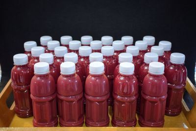 Close-up of drinks in bottles against black background