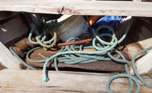 Close-up of rope tied up on wood