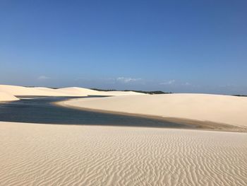 Scenic view of desert against clear blue sky