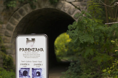 Close-up of information sign against trees