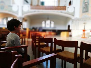 Boy sitting on table