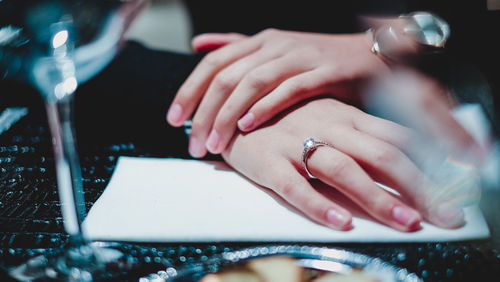 Midsection of couple holding hands