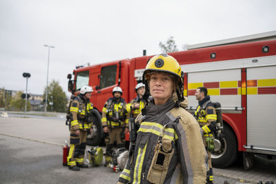 Female firefighter in front of fire engine