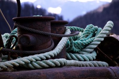 Close-up of rope tied on cleats at harbor