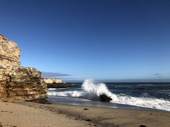 Scenic view of sea against clear blue sky
