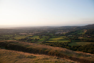 Scenic view of landscape against clear sky during sunset