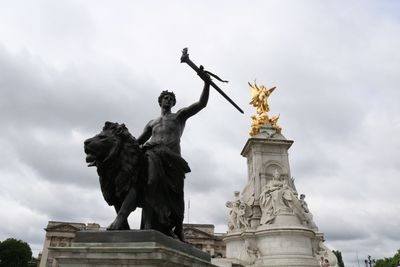 Low angle view of statue against cloudy sky