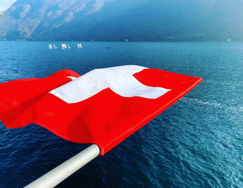 High angle view of flag on sea against mountain