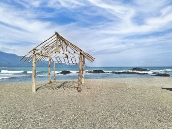 Lifeguard hut on beach against sky