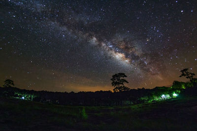 Scenic view of star field over landscape at night