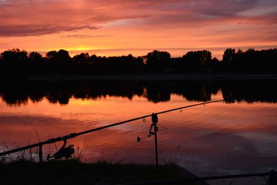 Scenic view of lake against orange sky