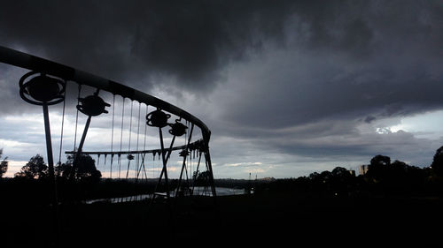Silhouette ferris wheel against sky at sunset