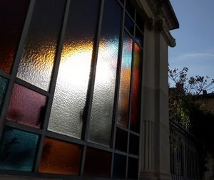 Low angle view of building seen through window