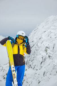Rear view of man skiing on snow covered landscape