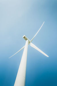 Low angle view of windmill against clear blue sky