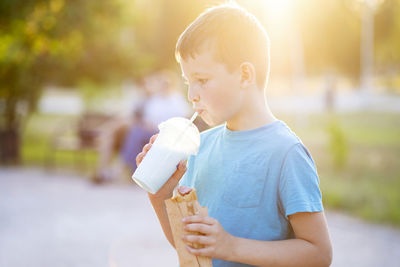 Young woman drinking water from bottle