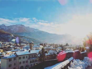 Town by mountains against sky