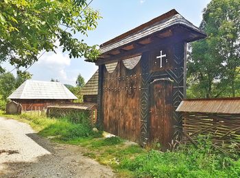 Abandoned house on field against sky