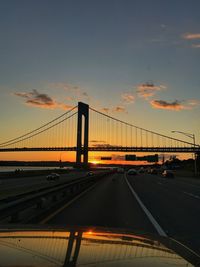 View of suspension bridge against sky during sunset