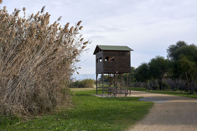 Built structure on field against sky
