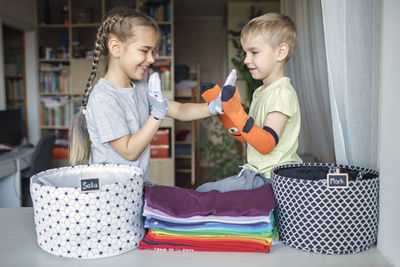 Siblings playing with sock at home