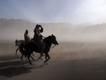 People riding horse on landscape