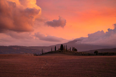 Scenic view of land against sky during sunset