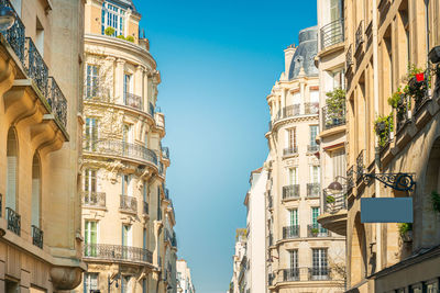 Low angle view of buildings against blue sky