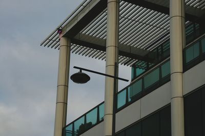 Low angle view of street light against building