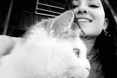 Close-up of young woman with cat