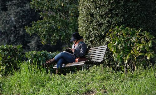 Man sitting on chair against plants