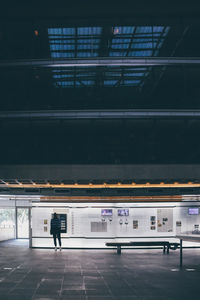 Rear view of people walking at railroad station