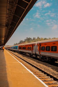 Train at railroad station against sky