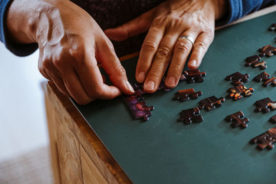 High angle view of woman playing with puzzle