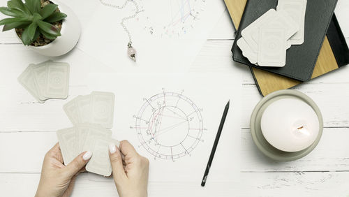 Cropped hands of person working on table