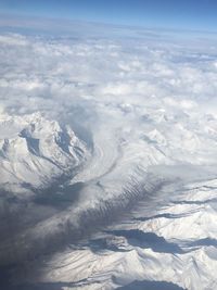 Aerial view of snowcapped mountains against sky