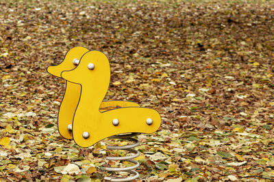 Close-up of yellow toy car on field