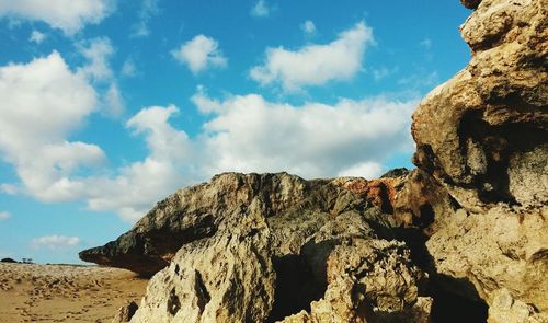 Low angle view of rock formation against sky