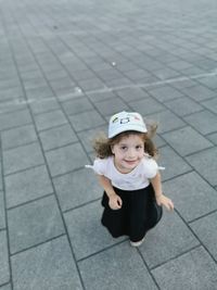 High angle portrait of cute girl on footpath
