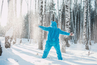 Full length of woman with ice cream in snow