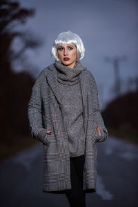 Portrait of young woman standing outdoors