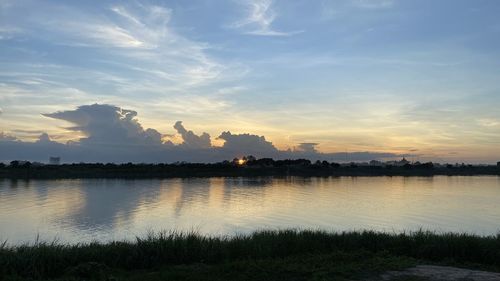 Scenic view of lake against sky at sunset
