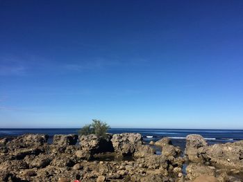 Scenic view of sea against clear blue sky