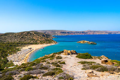 High angle view of bay against clear blue sky